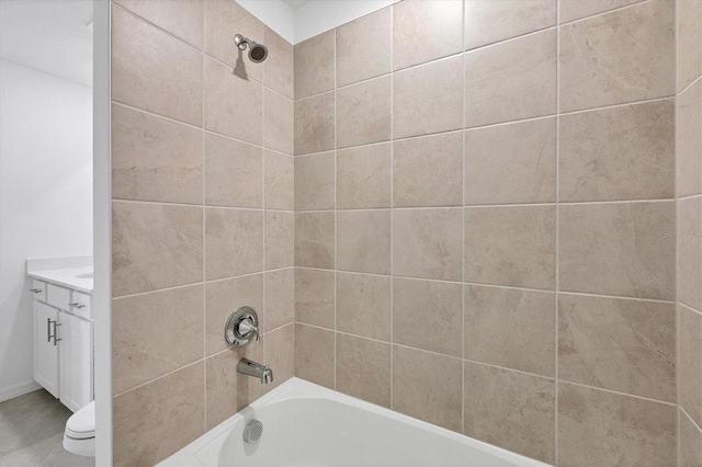 full bathroom with toilet, vanity, and tiled shower / bath