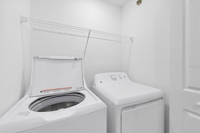 laundry area with independent washer and dryer