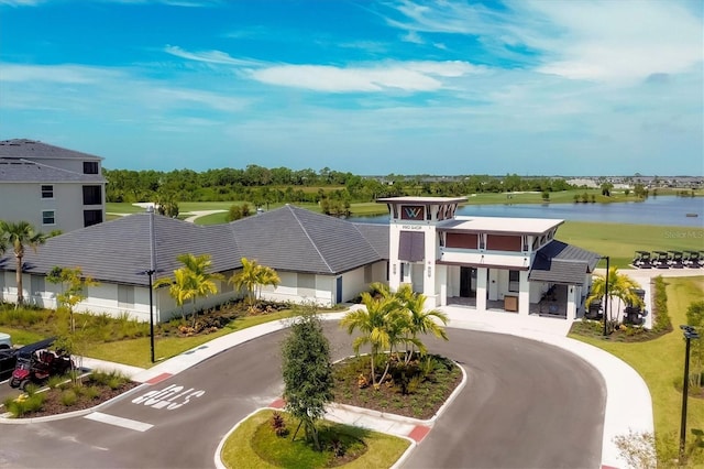 view of front of home with a balcony and a water view