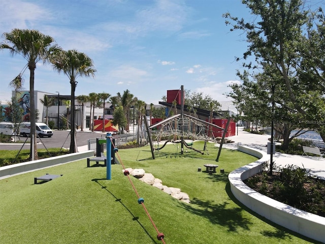 view of property's community with a playground and a yard