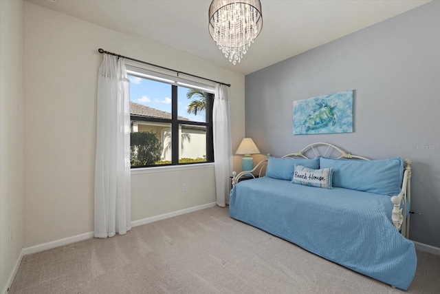 carpeted bedroom with an inviting chandelier