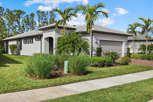 view of front of property with a garage and a front lawn