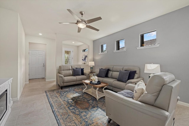 tiled living room featuring ceiling fan