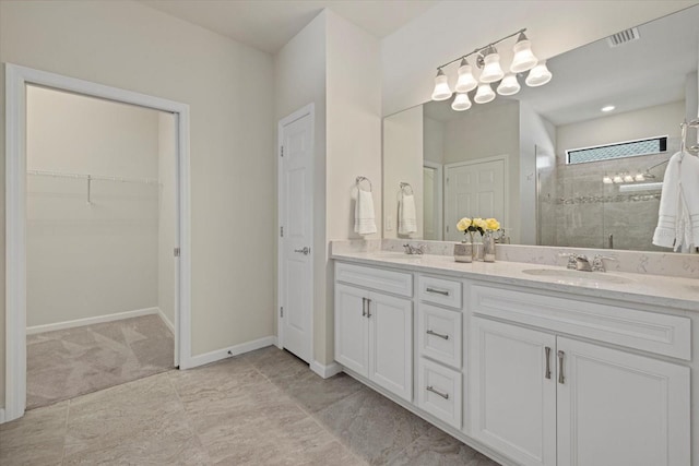 bathroom featuring vanity and an enclosed shower