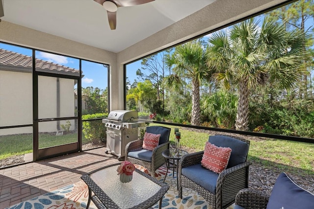 sunroom / solarium featuring ceiling fan