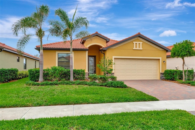 view of front of house with a garage and a front lawn