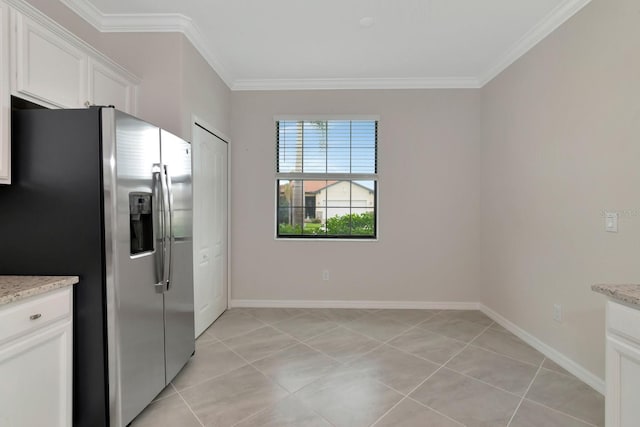 kitchen with baseboards, ornamental molding, and stainless steel fridge with ice dispenser