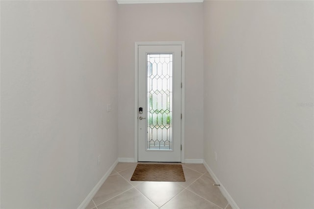 doorway featuring light tile patterned floors and baseboards