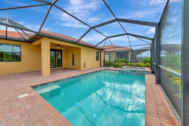 view of swimming pool featuring a patio area, a pool with connected hot tub, a lanai, and a ceiling fan