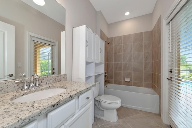 bathroom featuring tile patterned flooring, vanity, toilet, and washtub / shower combination