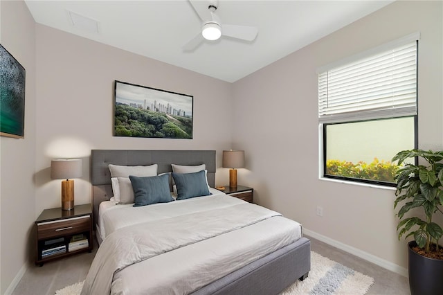 bedroom with baseboards, multiple windows, light carpet, and visible vents