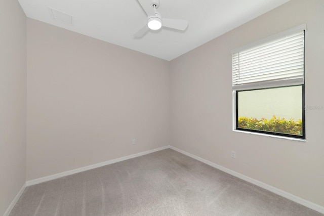 unfurnished room with ceiling fan, baseboards, and carpet floors