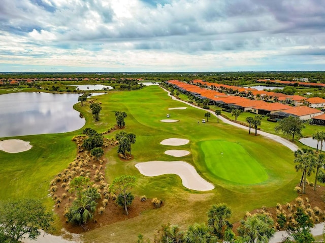 bird's eye view featuring golf course view and a water view