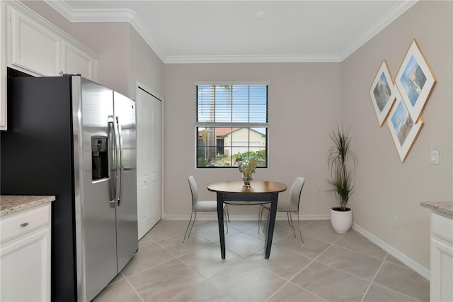 dining room with light tile patterned floors, baseboards, and ornamental molding