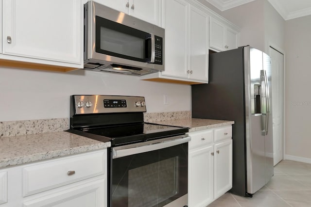 kitchen featuring light stone counters, appliances with stainless steel finishes, light tile patterned flooring, white cabinets, and crown molding