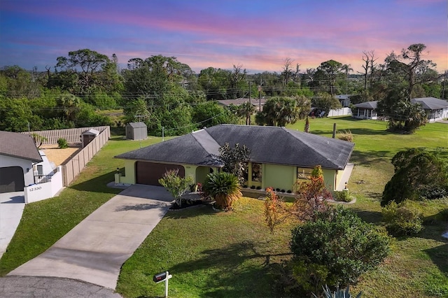 view of front facade featuring a yard and a garage