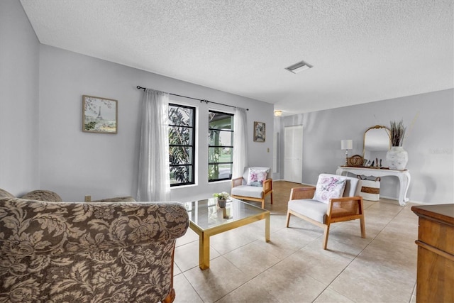 living room with light tile patterned floors and a textured ceiling