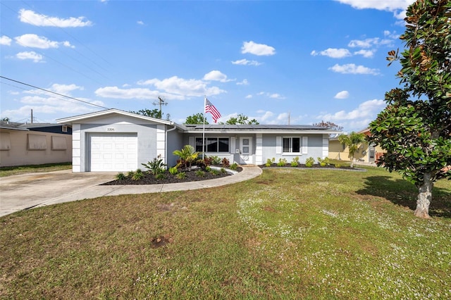 ranch-style home with a garage and a front lawn