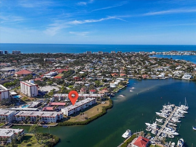 birds eye view of property with a water view and a city view