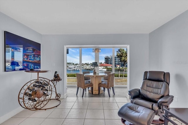 sitting room featuring a water view and light tile patterned floors