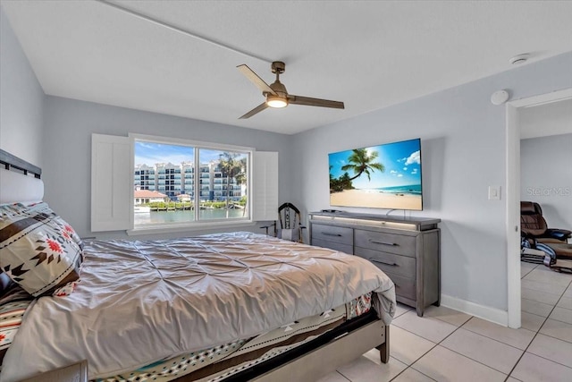 tiled bedroom featuring ceiling fan