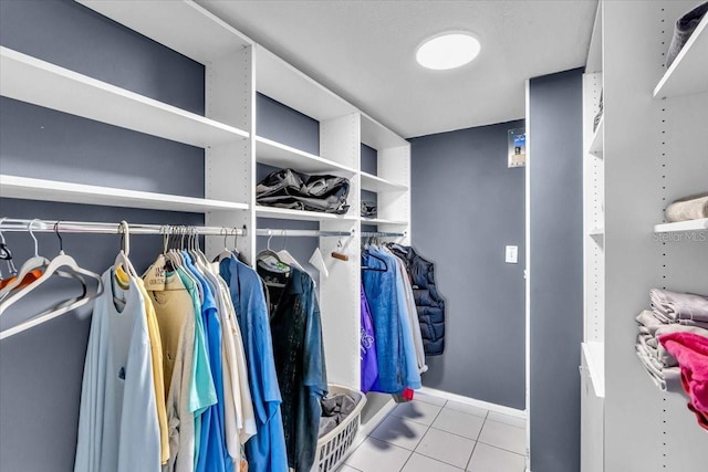 spacious closet with light tile patterned floors