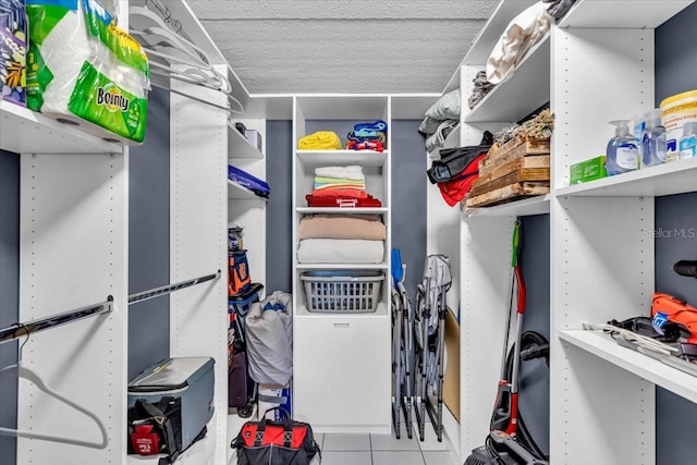 walk in closet with light tile patterned floors