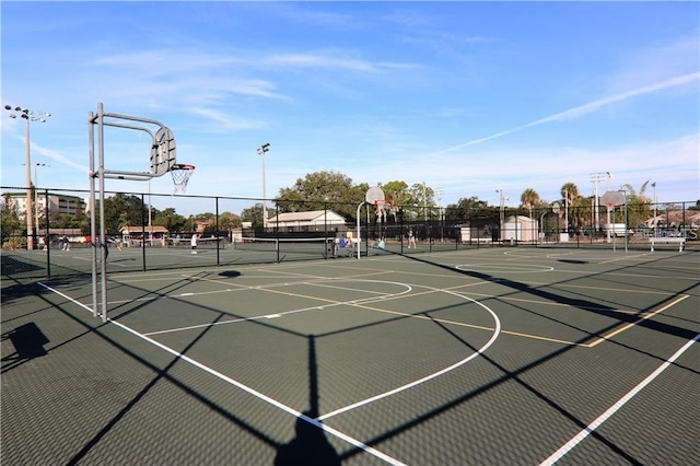 view of basketball court featuring tennis court