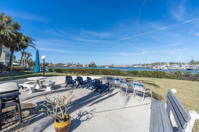 view of patio / terrace with a grill and a water view