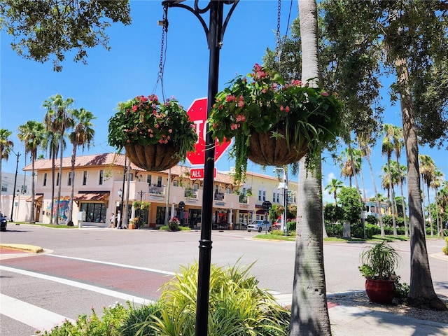 view of street with sidewalks, street lights, and curbs