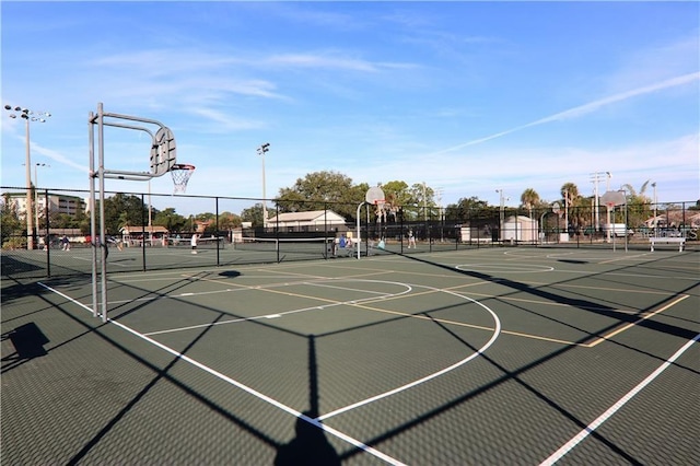 view of basketball court with community basketball court and fence