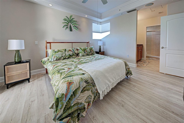 bedroom featuring ceiling fan, light wood-type flooring, ornamental molding, and connected bathroom