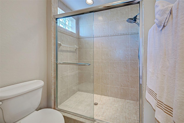 bathroom with toilet and walk in shower