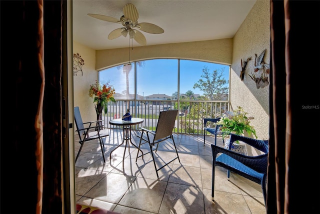 sunroom / solarium featuring ceiling fan