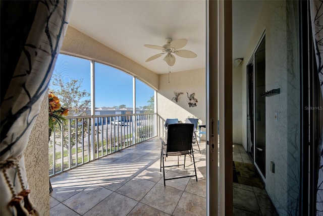 sunroom featuring ceiling fan