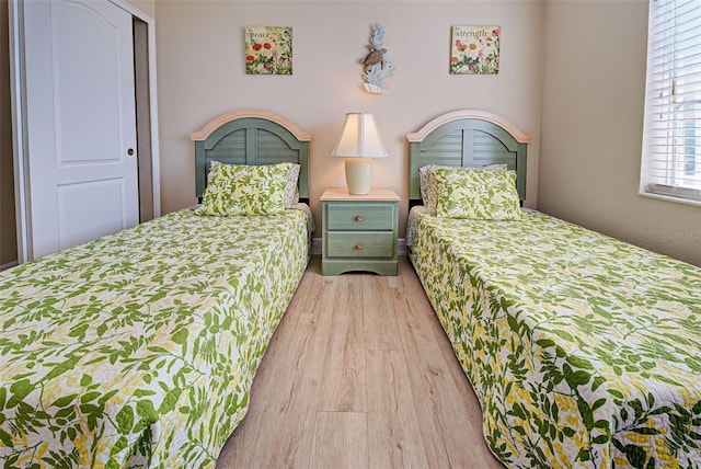 bedroom with a closet and light wood-type flooring