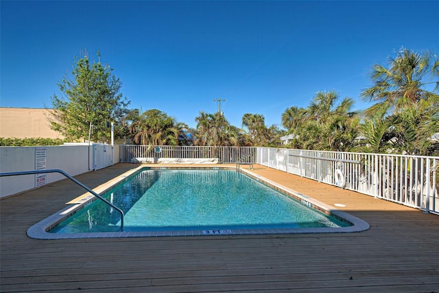 view of swimming pool with a wooden deck