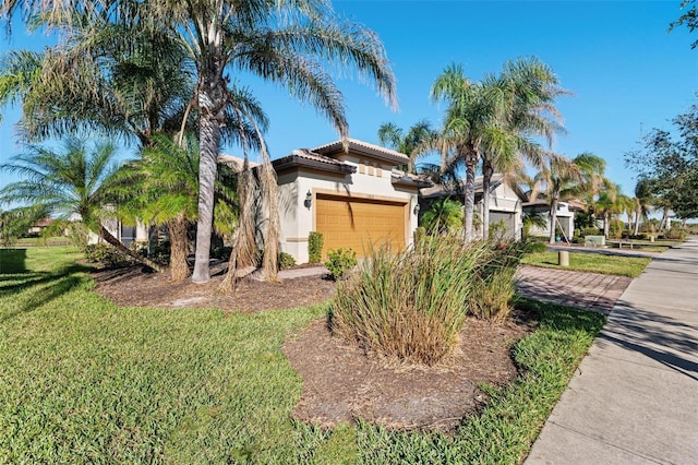 view of side of property with a lawn and a garage