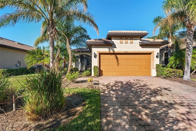 mediterranean / spanish home featuring a garage