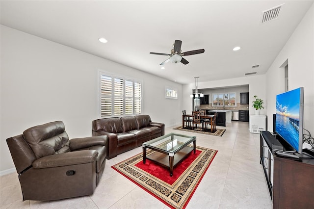 tiled living room featuring ceiling fan