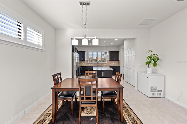 tiled dining room with a healthy amount of sunlight