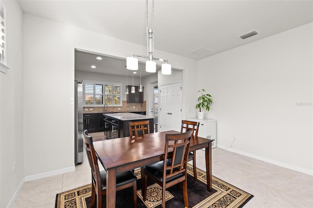 dining space with sink and light tile patterned floors