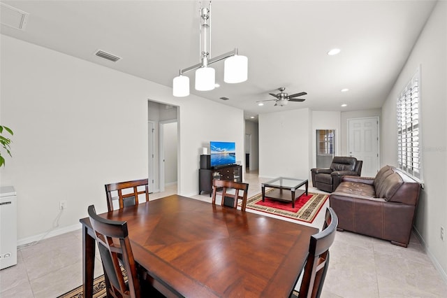 tiled dining space with ceiling fan