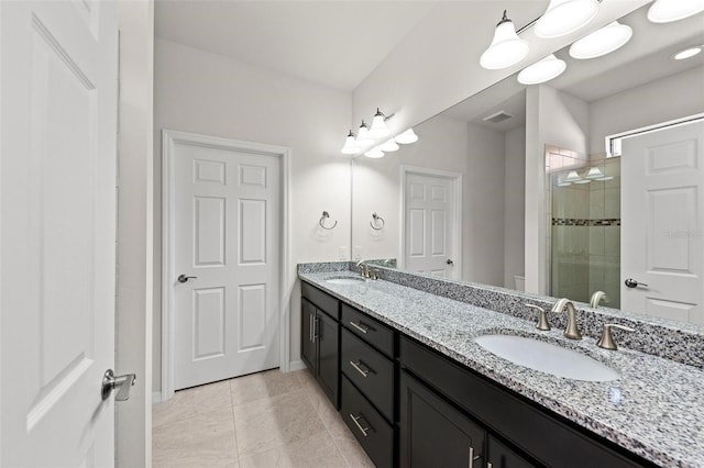 bathroom featuring tile patterned flooring, vanity, and a shower with shower door