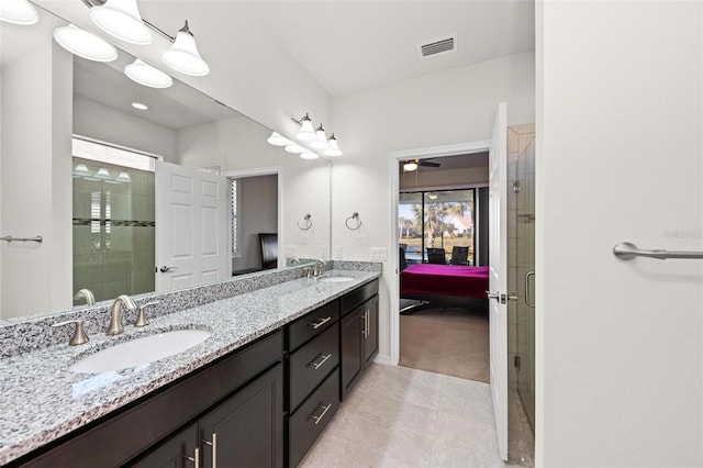 bathroom with ceiling fan, tile patterned flooring, vanity, and a shower with door