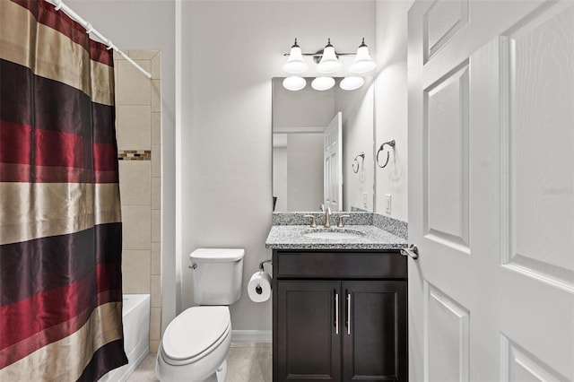 full bathroom with tile patterned floors, vanity, toilet, and shower / bath combo with shower curtain