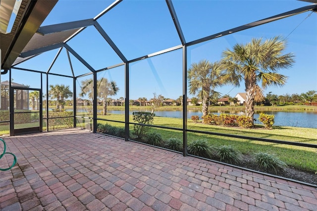 unfurnished sunroom featuring a water view