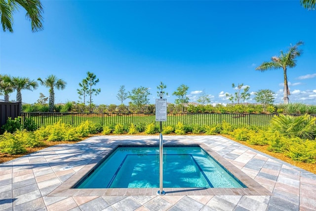 view of pool with a hot tub