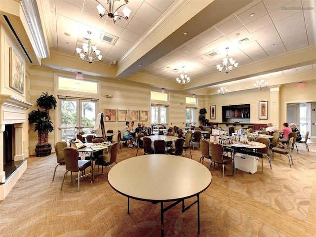 dining space with light colored carpet and crown molding