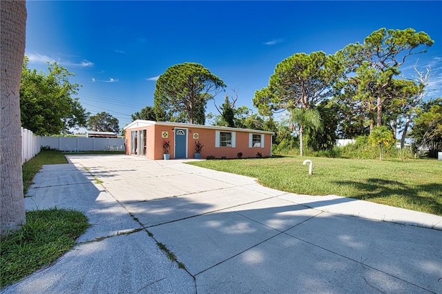 ranch-style home with a front lawn